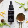 Soothe Compound resting on a marble tray surrounded by chamomile flowers and calendula petals.